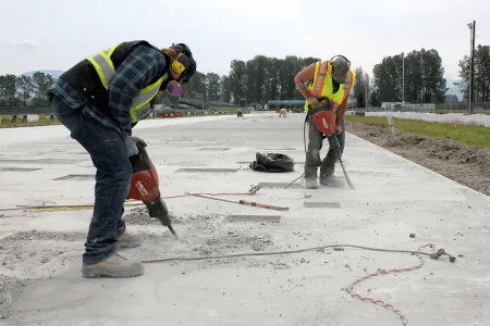 Crew cutting and preparing a concrete slab on a Northwest Arkansas job site